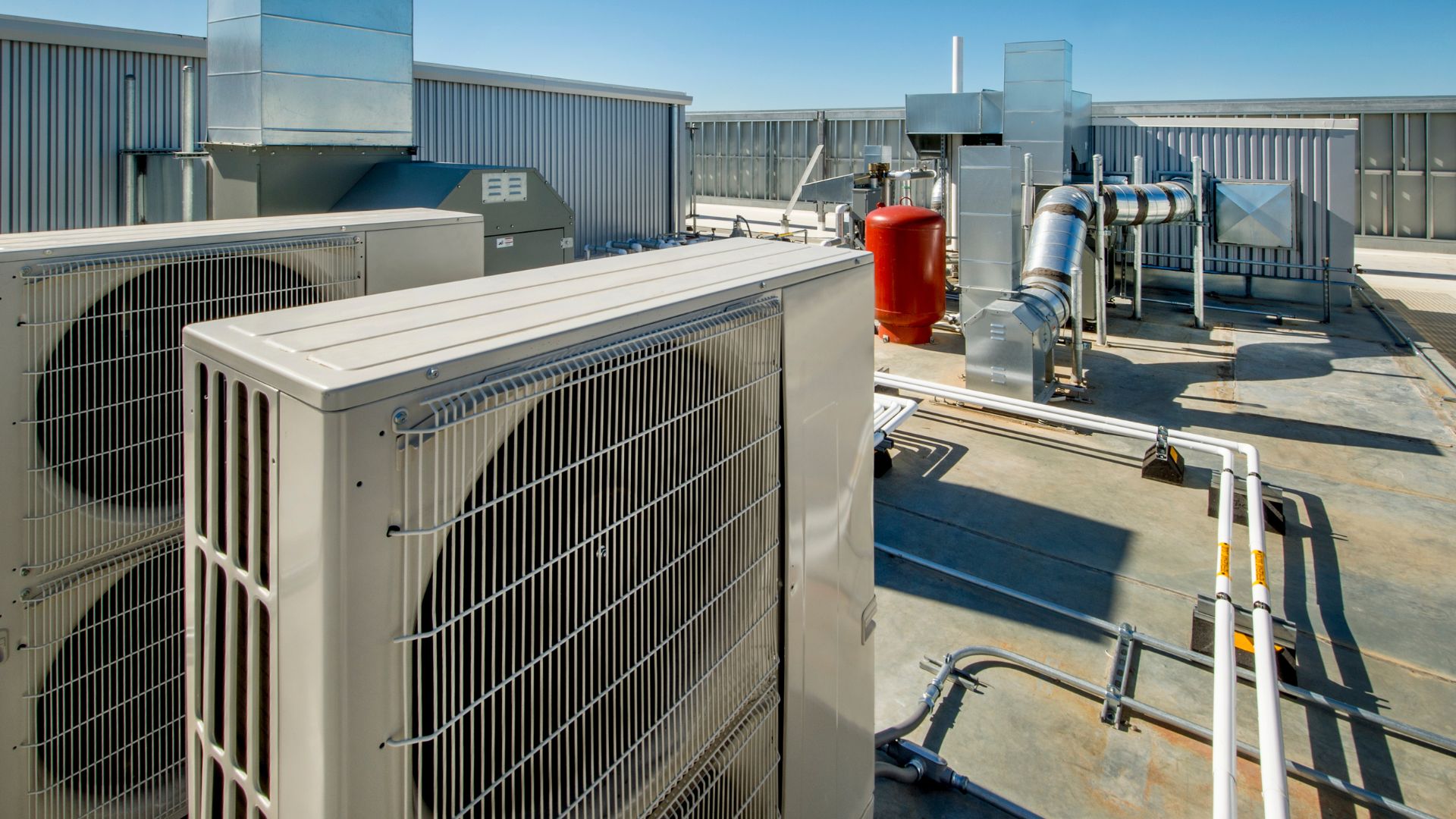 Commercial HVAC system with air conditioning units on building rooftop